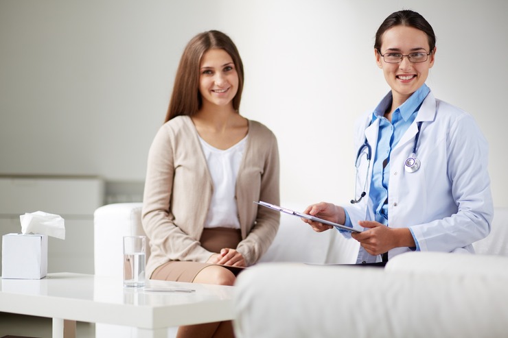 Clinician talking with a smiling young woman